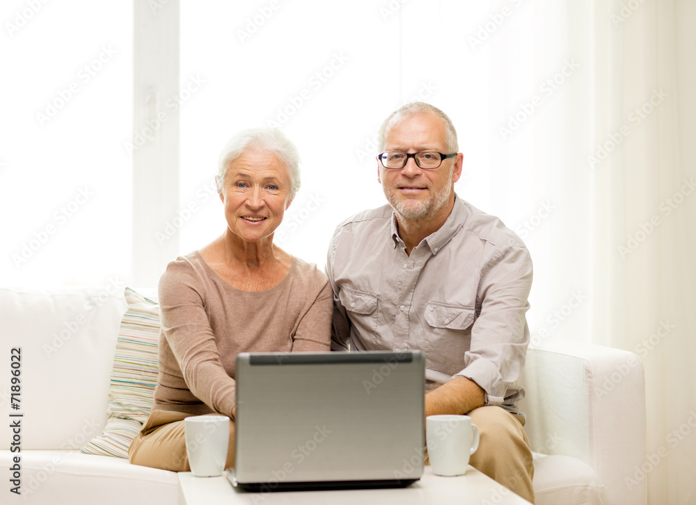 happy senior couple with laptop and cups at home happy senior couple with laptop and cups at home