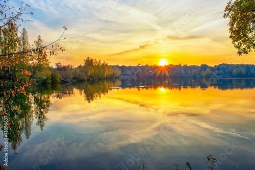 Autumn sunset on the lake © alisluch