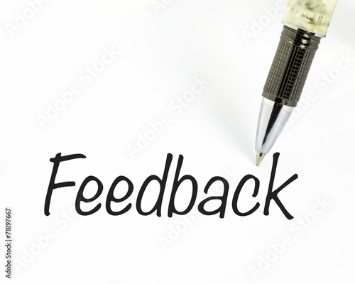 Pen writes feedback word on paper