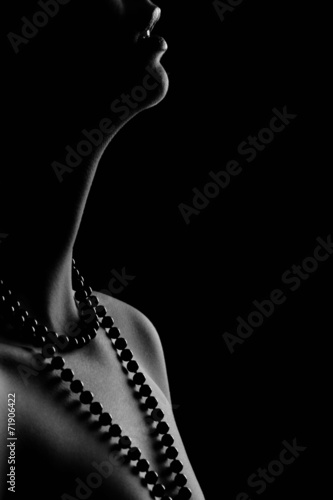 Woman's pearl passion isolated black bacground