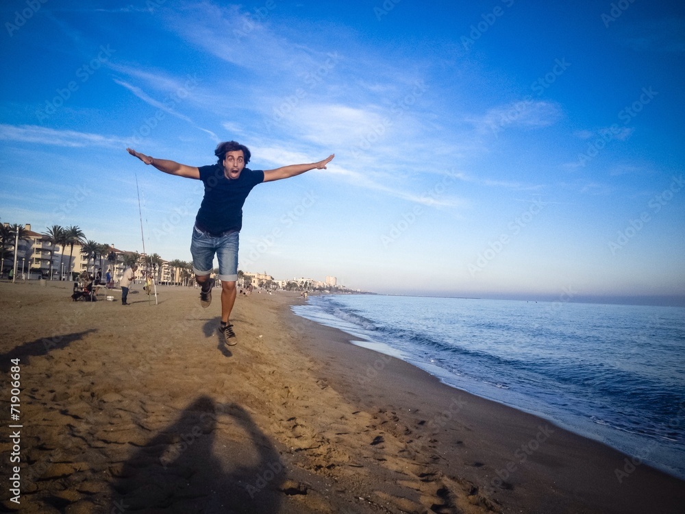 Plakat man jumping on the beach