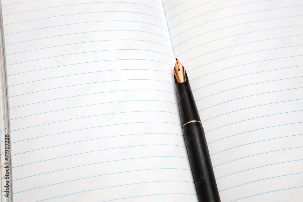 Fountain pen on an opened notepad Fountain pen on an opened notepad