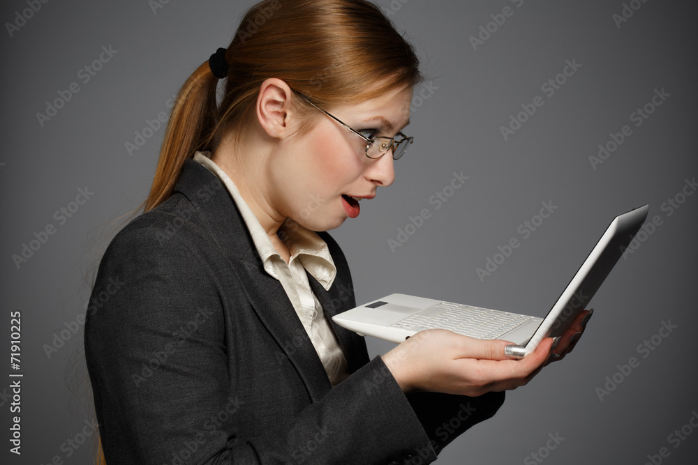 Surprised business woman with white netbook Surprised business woman with white netbook