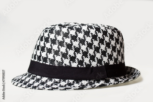 Hat with a houndstooth pattern on a white background