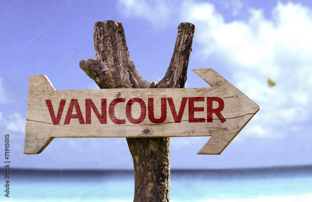 Vancouver wooden sign with a beach on background