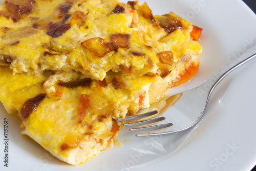 scrambled eggs with carrots and onions on a white plate
