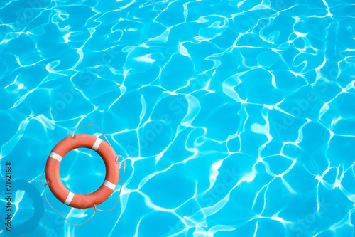 Lifebuoy on blue water surface concept