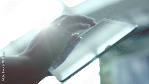 Wallpaper Mural Woman using tablet computer against bright light Torontodigital.ca