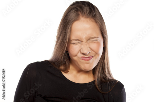 young woman with sour gesture photo