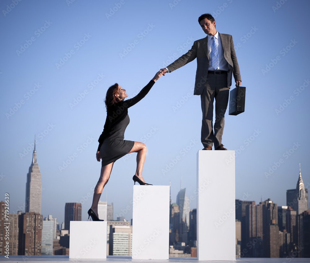 Businessman Helping a Colleague to Succeed - obrazy, fototapety, plakaty 
