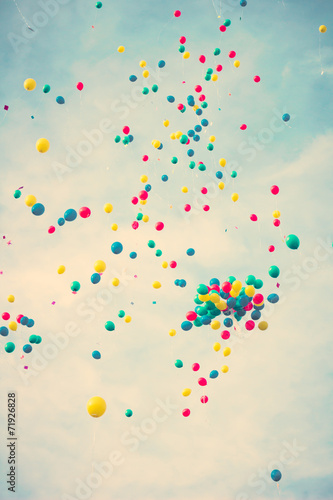 Bunch of colorful vintage helium balloons in flight