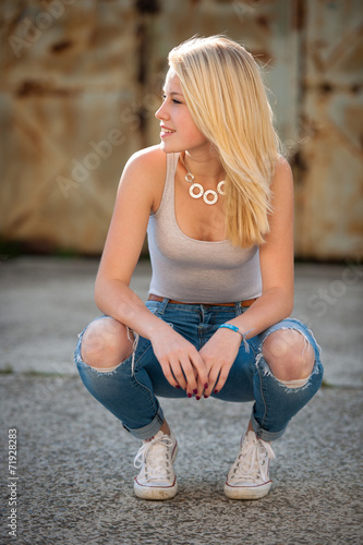 young blonde caucasian girl alone on a street photo