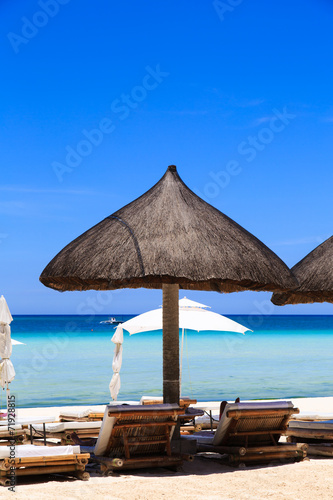 Beach chairs on tropical sand beach