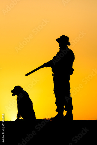 Silhouette of the hunter with a dog