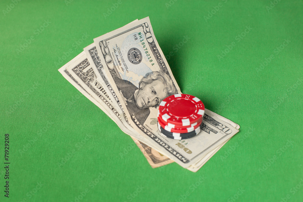 Fotografie dollars and poker chips on a green table