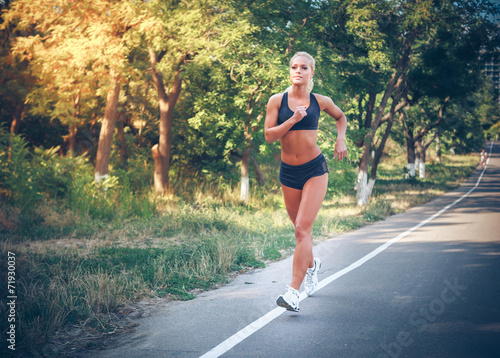 young woman jogging in the park in summer © Andriy Petrenko