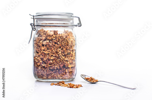 Bild auf Leinwand Glass jar of homemade granola with spoon