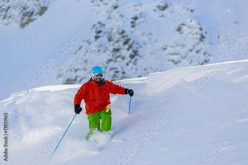 Skiing, Skier, Freeride in fresh powder snow - man skiing downhi