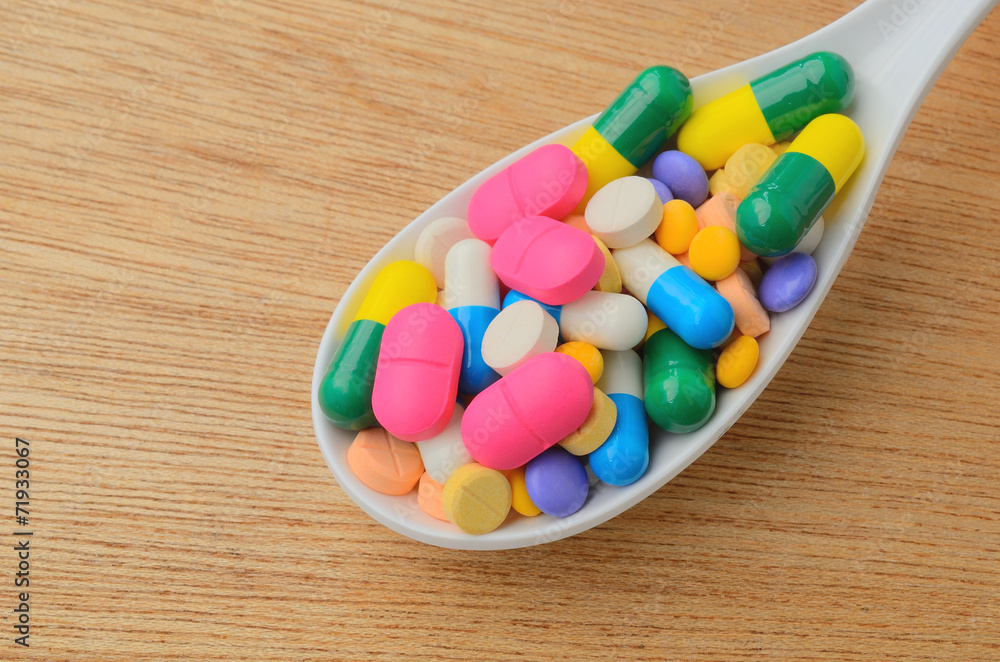 colorful medicine capsule pill on spoon colorful medicine capsule pill on spoon