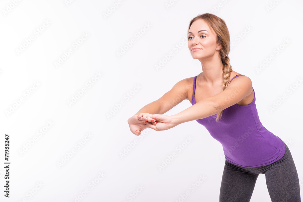 Healthy young sportswoman does the exercises Healthy young sportswoman does the exercises