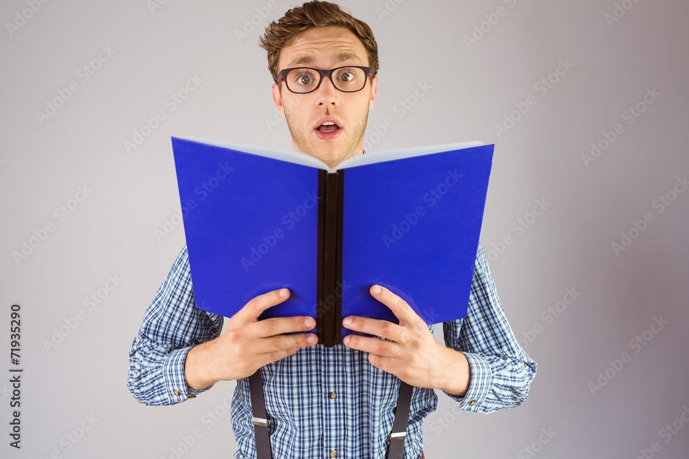Geeky businessman holding a book Geeky businessman holding a book