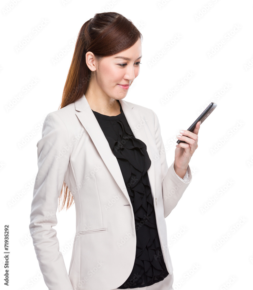 Businesswoman look at the message on mobile phone Businesswoman look at the message on mobile phone