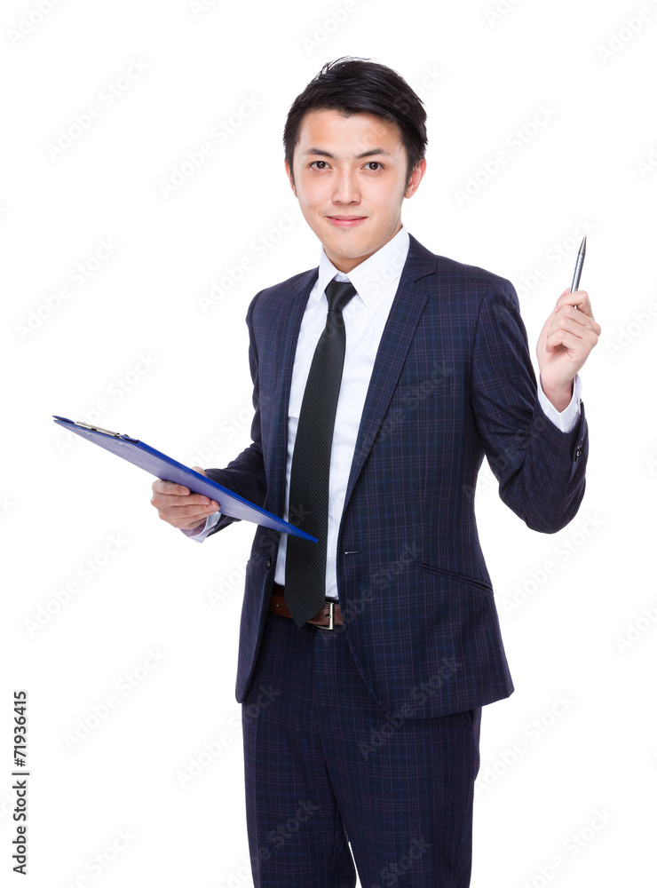 Asian businessman with clipboard and pen up