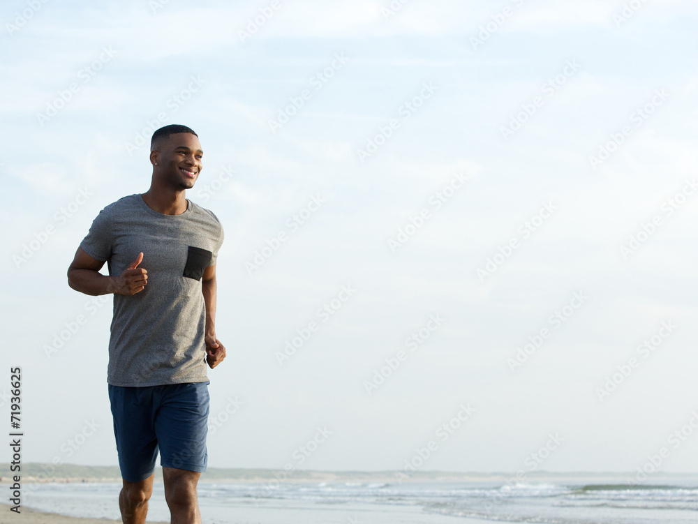 Active young man jogging at the beach Active young man jogging at the beach