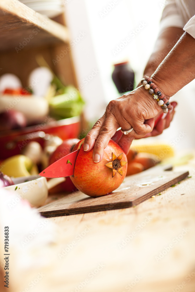 Senior woman preparing fruit salad Senior woman preparing fruit salad