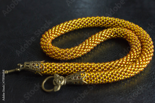 Necklace from yellow transparent beads against a dark background