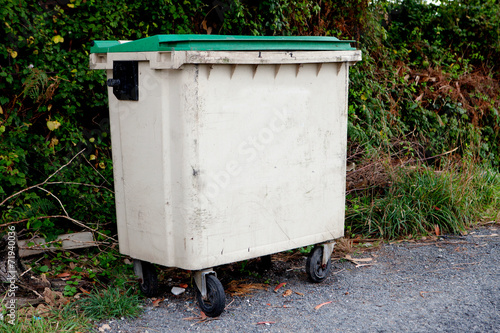 Waste container with green lid