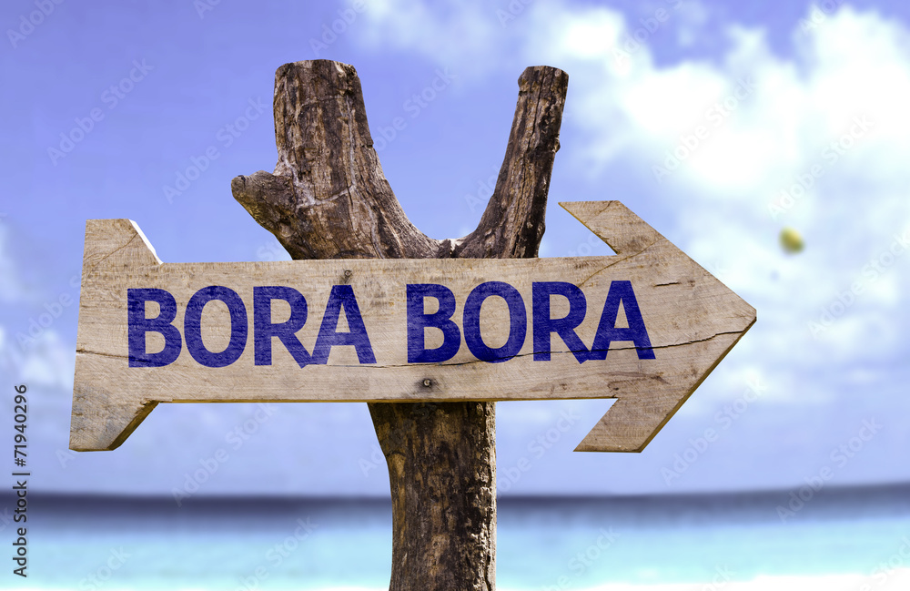 Bora Bora wooden sign with a beach on background