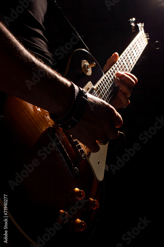 musician playing on guitar