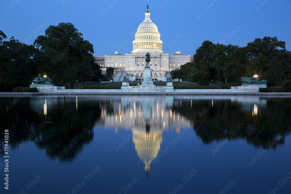 Capitol building in Washington illuminated at night.