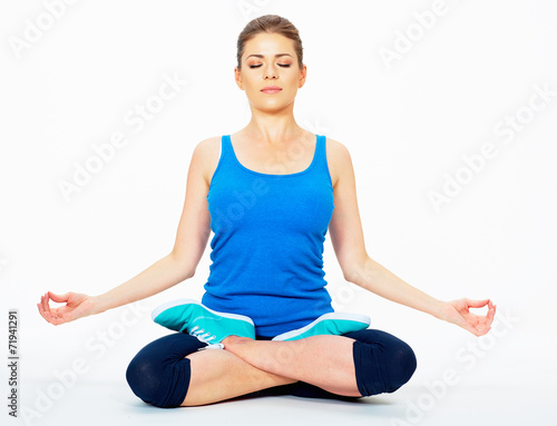 young woman in yoga pose sitting on a floor