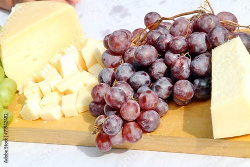 Asiago cheese and black grapes and white grape