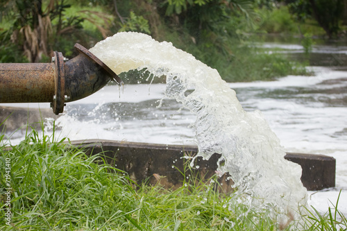 stream of artesian water from the old rusty pipe.