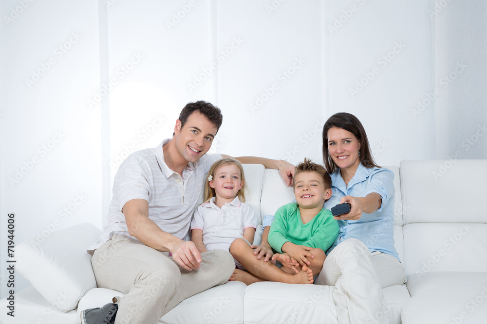 young family posing on sofa young family posing on sofa