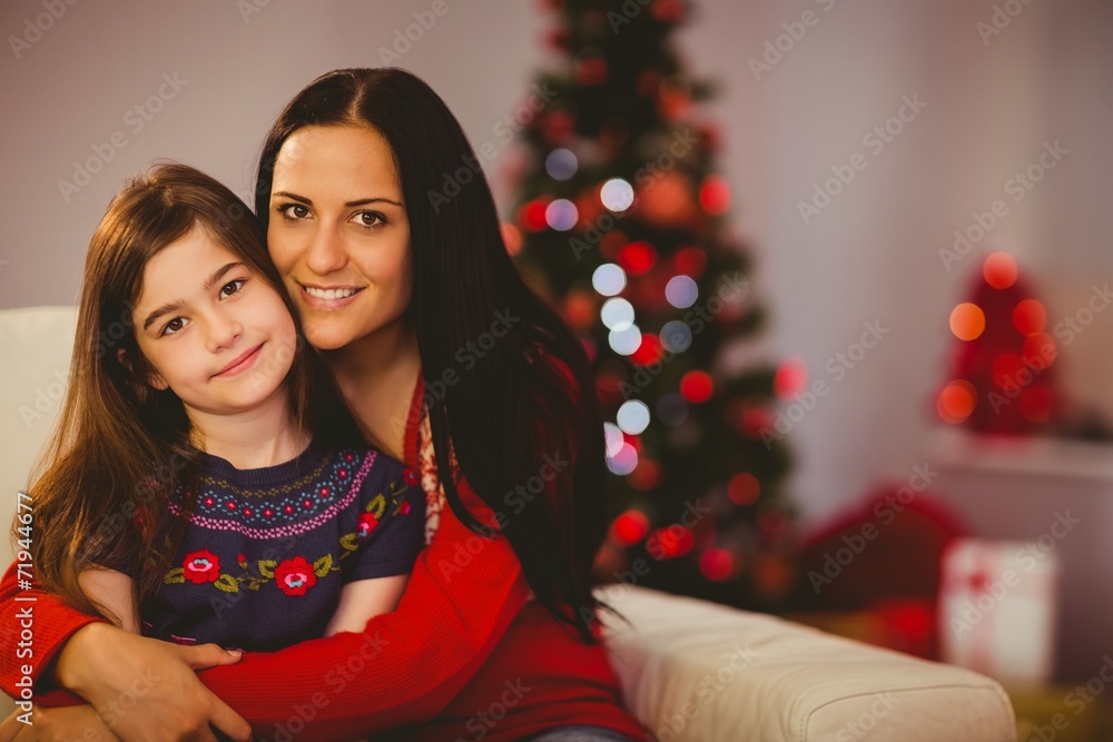 Festive mother and daughter smiling at camera Festive mother and daughter smiling at camera