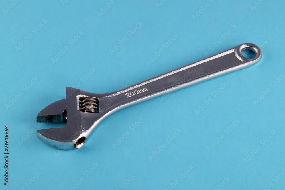 Adjustable wrench or spanner on a blue background. Adjustable wrench or spanner on a blue background.