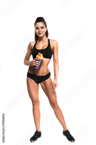 athletic young woman with protein shake bottle