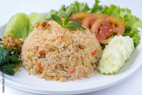 Rice and vegetables on a plate with a white background.