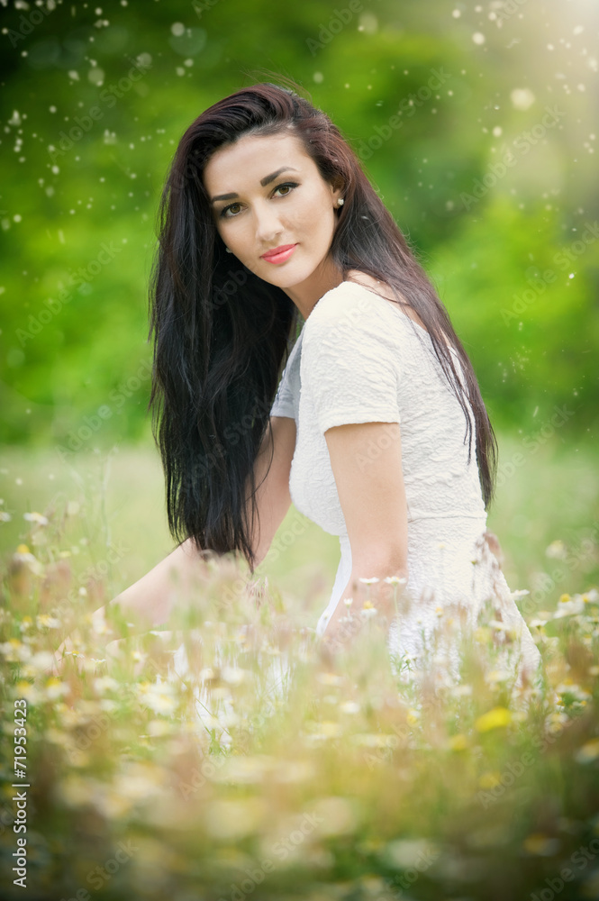 Beautiful young woman in wild flowers field Beautiful young woman in wild flowers field