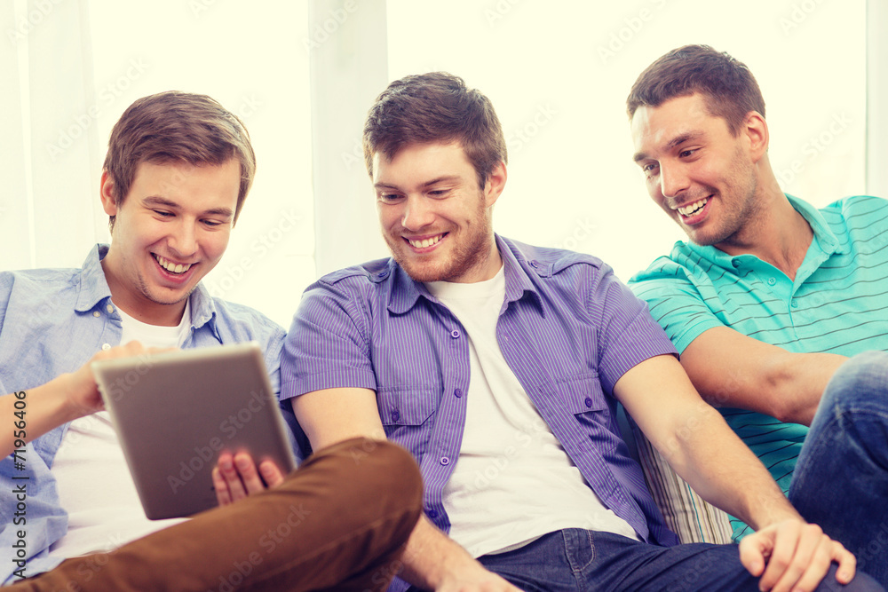 smiling friends with tablet pc computers at home smiling friends with tablet pc computers at home