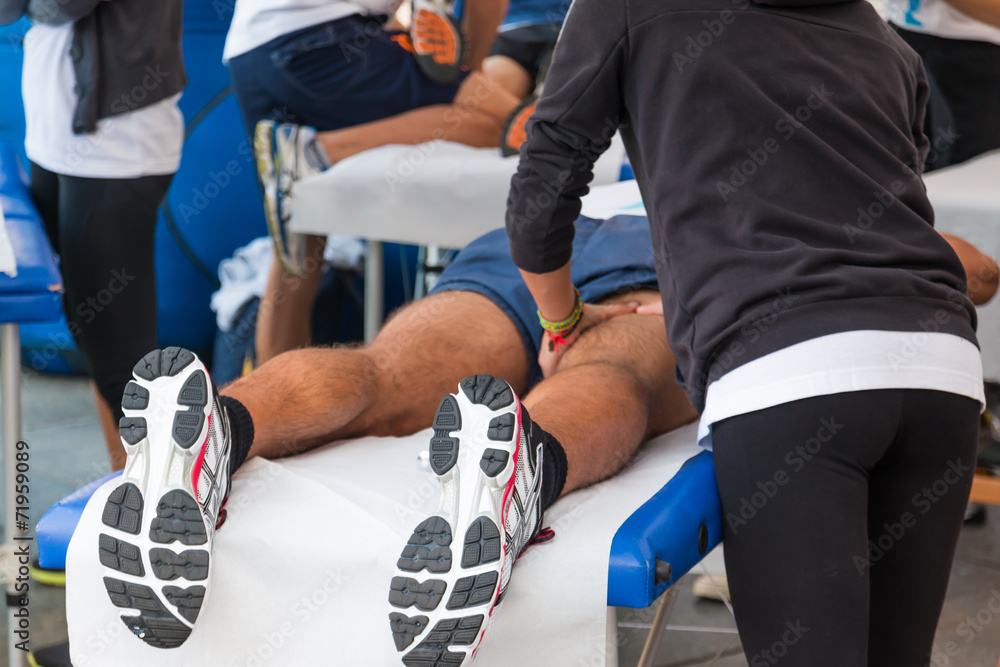athletes relaxation massage before sport event - obrazy, fototapety, plakaty 