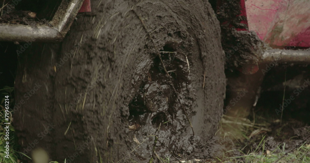 Turning wheel of a 4x4 offroad vehicle on the mud Turning wheel of a 4x4 offroad vehicle on the mud