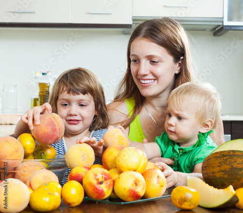 Mother with daughters with melon photo