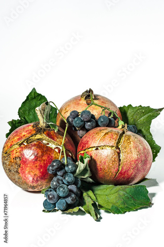 Still life on white background   pomegranate and grape 