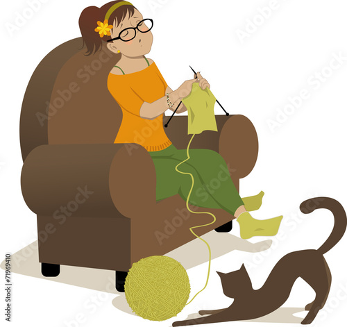 Woman knitting and cat playing with a ball of yarn