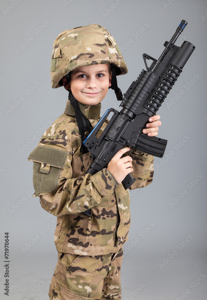 Young boy dressed like a soldier with rifle Young boy dressed like a soldier with rifle